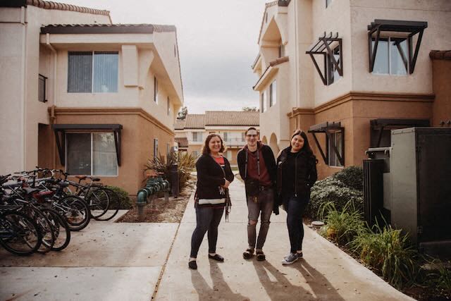 Residents smile near bike racks at The Colleges at La Rue